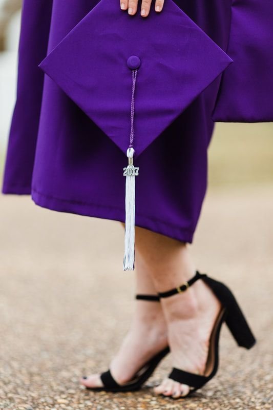 Photo of a 2017 NSU graduate holding their cap.
